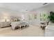 Spacious main bedroom with a tufted headboard, bench, plantation shutters, and neutral decor at 8934 Winged Bourne Dr, Charlotte, NC 28210
