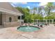 Pool area with a hot tub, stone pavers, and lush greenery at 8934 Winged Bourne Dr, Charlotte, NC 28210