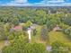 Expansive aerial view of property surrounded by lush greenery and a long driveway leading to the home at 915 Gate Rd, Monroe, NC 28112