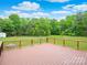 Expansive deck overlooking a spacious backyard and surrounded by lush greenery and blue skies at 915 Gate Rd, Monroe, NC 28112