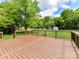 Elevated backyard deck with black railings offers a lovely view of the surrounding green backyard at 915 Gate Rd, Monroe, NC 28112