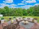 A backyard deck includes a seating area, a table with chairs, grill and a beautiful view of the backyard at 915 Gate Rd, Monroe, NC 28112