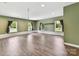 Expansive bonus room featuring wood-look flooring, abundant natural light, and neutral walls at 915 Gate Rd, Monroe, NC 28112