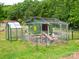 Fenced-in chicken coop beside a greenhouse among the green grass at 915 Gate Rd, Monroe, NC 28112