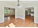 Bright dining room featuring wood floors, a decorative chandelier, and multiple entryways for easy access at 915 Gate Rd, Monroe, NC 28112