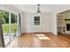 Dining area with wood floors, sliding glass doors to deck, large window, and elegant lighting at 915 Gate Rd, Monroe, NC 28112