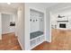 Bright entryway featuring hardwood floors, a built-in storage bench, and seamless access to the living area at 915 Gate Rd, Monroe, NC 28112