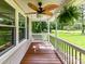 Inviting front porch featuring a ceiling fan, hanging ferns, and a comfortable swing, perfect for relaxing at 915 Gate Rd, Monroe, NC 28112