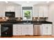 Stylish kitchen featuring stainless appliances, modern dishwasher, white cabinets, and mosaic tile backsplash at 915 Gate Rd, Monroe, NC 28112