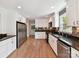 Spacious kitchen features stainless appliances, granite countertops, white cabinets, and a stylish backsplash at 915 Gate Rd, Monroe, NC 28112
