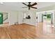 Open-concept living room with hardwood floors, offering views into the kitchen and backyard patio at 915 Gate Rd, Monroe, NC 28112