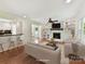 Spacious living room with fireplace, ceiling fan, hardwood floors, and built-in shelving at 915 Gate Rd, Monroe, NC 28112
