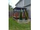 A lush backyard featuring a covered deck, small trees, and a wooden fence at 932 3Rd Street Sw Pl, Hickory, NC 28602