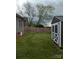 A wide-open backyard with a small shed in the corner and surrounded by a tall wooden fence at 932 3Rd Street Sw Pl, Hickory, NC 28602