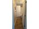Hallway with wood-like floors leading to a bathroom with a tub/shower combo at 932 3Rd Street Sw Pl, Hickory, NC 28602