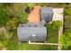 An aerial view of the property showcasing the brick patio, mature trees, and lush landscaping at 103 Colonel Richard Rankin Dr, Stanley, NC 28164