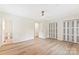 Bright bedroom features wood floors, ceiling fan, and closet at 103 Colonel Richard Rankin Dr, Stanley, NC 28164