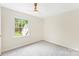 Large, empty room featuring plush carpeting, bright natural light, and fresh white trim at 103 Colonel Richard Rankin Dr, Stanley, NC 28164