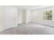 A simple room featuring neutral walls, plush carpeting, natural light, and multiple access doors at 103 Colonel Richard Rankin Dr, Stanley, NC 28164