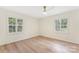 Empty bedroom features hardwood floors, white trim, and a ceiling fan to highlight its spaciousness at 103 Colonel Richard Rankin Dr, Stanley, NC 28164