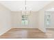 A dining room with hardwood flooring, and a chandelier, bathed in natural light at 103 Colonel Richard Rankin Dr, Stanley, NC 28164