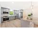 The kitchen has stainless steel appliances, gray cabinets, and stone countertops at 103 Colonel Richard Rankin Dr, Stanley, NC 28164