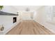 Living room features a brick fireplace, bright lighting, and hardwood floors at 103 Colonel Richard Rankin Dr, Stanley, NC 28164