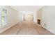 Bright living room with plantation shutters, fireplace, and wood flooring at 103 Colonel Richard Rankin Dr, Stanley, NC 28164