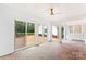Enclosed sunroom features brick flooring, access to the patio, and natural light at 103 Colonel Richard Rankin Dr, Stanley, NC 28164