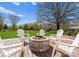 Backyard featuring a wood deck, stone fire pit, and outdoor seating at 1052 Perth Rd, Troutman, NC 28166