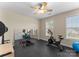 Exercise room featuring weights, workout machine, rubber floor, and mirrored wall at 1052 Perth Rd, Troutman, NC 28166