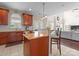 Kitchen with wooden cabinets and granite countertops with bar that opens up to the living room at 1052 Perth Rd, Troutman, NC 28166