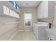 Laundry room with washer and dryer, cabinets and window at 1052 Perth Rd, Troutman, NC 28166