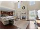 Bright living room boasts a soaring ceiling, fireplace, many windows, and wood floors at 1052 Perth Rd, Troutman, NC 28166