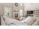 Bright living room boasts a soaring ceiling, fireplace, and wood floors at 1052 Perth Rd, Troutman, NC 28166