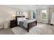 Bedroom with a bed, two nightstands and three windows with curtains at 1052 Perth Rd, Troutman, NC 28166