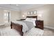 Bedroom with a bed, two nightstands, three windows with curtains and en suite bath at 1052 Perth Rd, Troutman, NC 28166