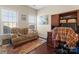 Cozy home office featuring hardwood floors, a sofa, and built in cabinets at 1052 Perth Rd, Troutman, NC 28166