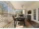 Screened porch with dining table, ceiling fan, and outdoor views at 1052 Perth Rd, Troutman, NC 28166