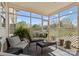 Relaxing screened porch with comfortable seating, plants, and open views at 1052 Perth Rd, Troutman, NC 28166