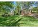Expansive backyard featuring a well-maintained lawn, mature trees, and beautifully landscaped surroundings at 10609 Oak Pond Cir, Charlotte, NC 28277