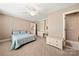 Cozy bedroom with an ensuite bathroom, ceiling fan, and built-in shelving at 10609 Oak Pond Cir, Charlotte, NC 28277
