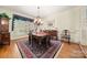 Traditional dining room with a chandelier, hardwood floors, and an elegant table set at 10609 Oak Pond Cir, Charlotte, NC 28277