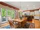 Dining room with a wooden table and view of the kitchen island and outdoor deck at 10609 Oak Pond Cir, Charlotte, NC 28277