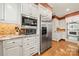 Kitchen cabinets with stainless steel microwave, oven, and refrigerator at 10609 Oak Pond Cir, Charlotte, NC 28277