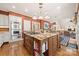Kitchen featuring a large island with a cooktop, seating, and stainless steel appliances at 10609 Oak Pond Cir, Charlotte, NC 28277