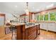 Kitchen island with granite countertop, cooktop, and seating, connecting to the living area at 10609 Oak Pond Cir, Charlotte, NC 28277