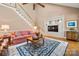 Cozy living room with a staircase, built-in shelving, and a plush rug, perfect for relaxation at 10609 Oak Pond Cir, Charlotte, NC 28277