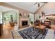 Spacious living room with hardwood floors, fireplace, and a seamless transition to the bright sunroom at 10609 Oak Pond Cir, Charlotte, NC 28277