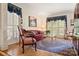 Comfortable living room featuring patterned rug and elegant furnishings with ample natural light at 10609 Oak Pond Cir, Charlotte, NC 28277